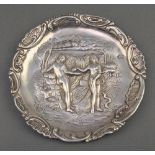 A 19th Century Continental repousse silver circular dish depicting Adam and Eve in the Garden of