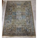 A green ground Persian style rug decorated hunting scenes 135" x 98"