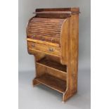 A Victorian oak student's roll top desk with three-quarter gallery and fitted interior, with