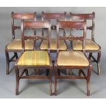 A set of 6 carved mahogany bar back dining chairs with carved and pierced mid rails, upholstered