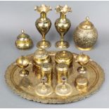 An oval Indian engraved brass tray 20" x 15", a pair of Benares brass vases 10", ditto jar and cover