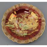 A Carlton Ware Rouge Royale plate decorated with figures in an Oriental garden 9" This plate has