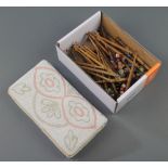 42 various turned wooden lace makers bobbins together with a rectangular bead work bag 4" x 7"