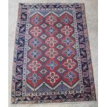 A Turkish tan and blue ground rug with 18 stylised stars to the centre 115" x 78"