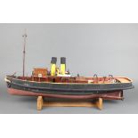 A Woodrise wooden model of Rescue Tug HMS Cartmel, raised on a wooden stand 30" x 20"