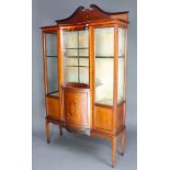 An Edwardian inlaid mahogany display cabinet the upper section with shaped raised back, the base