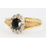 An 18ct yellow gold sapphire and diamond ring size P