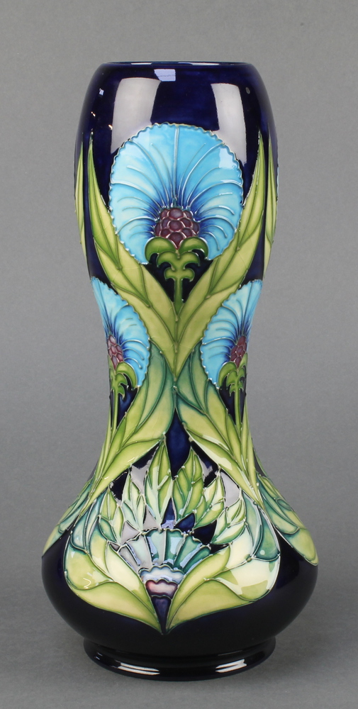 A contemporary Moorcroft waisted oviform vase, the blue ground with stylised flowers no.198/300 11",