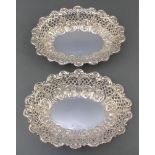 A pair of Victorian silver repousse oval dishes with scroll and pierced decoration Henry Wilkinson