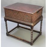 An 18th Century carved oak bible box with heavily carved panels to the sides, fitted a drawer,