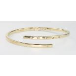 A 9ct yellow gold 5 stone diamond set bangle