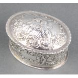 A modern oval silver repousse trinket box decorated with cavorting cherubs Birmingham 1978, 50 grams