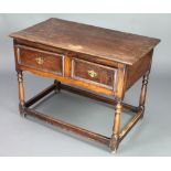 A 17th/18th Century oak side table fitted 2 frieze drawers, raised on turned and block supports with