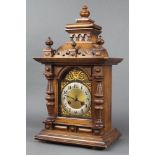 A 19th Century Continental striking bracket clock with arched dial and Arabic numerals contained