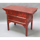 A Chinese red lacquered side table fitted 2 drawers with brass drop handles 33"h x 42"w x 21 1/2"d