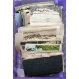 A collection of black and white and coloured postcards and a small stock book of stamps and loose