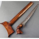 A Kris with 9 1/2" blade complete with wooden scabbard There is corrosion to the blade and a section