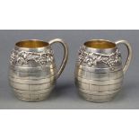 A pair of Portuguese silver baluster mugs with vinous decoration 3 1/4"