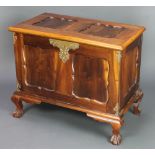 An Italian style walnut coffer with hinged lid and brass mounts raised on cabriole claw and ball