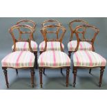 A set of 6 Victorian carved mahogany balloon back dining chairs with shaped mid rails, raised on