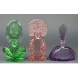 An Art Deco pink glass scent bottle with moulded floral stopper 7", a green ditto 7" and a purple