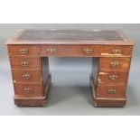 A mahogany kneehole desk with black inset writing surface above 1 long and 8 short drawers 28"h x