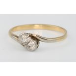 An 18ct yellow gold 2 stone diamond cross-over ring size M 1/2