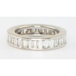 An 18ct white gold baguette cut diamond full eternity ring size L, approx. 3ct