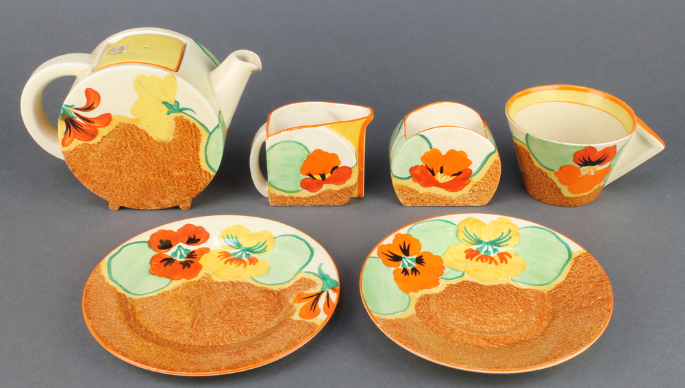 A Clarice Cliff Bizarre Nasturtium part tea set comprising teapot and lid, cream jug, sugar bowl,