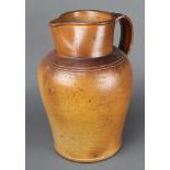 A 19th Century stoneware jug with simple handle 14" and a tapered measure 3" The jug lip is