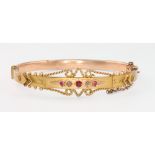 A Victorian 9ct yellow gold ruby and diamond Etruscan style bangle 7.9 grams