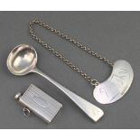 A silver salt spoon, a vesta and a whisky label