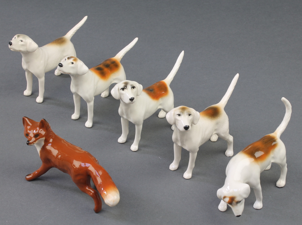 A Beswick figure of a standing fox 4 1/2" and 5 Beswick beagles 3 1/2"