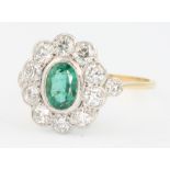 An 18ct yellow gold emerald and diamond cluster ring size O
