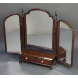 An Edwardian triple plate arch shaped dressing table mirror contained in a mahogany swing frame, the