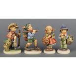 Four Hummel figures - girl with basket 355 5", boy with basket of chicks 378 5", boy with rucksack