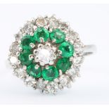 An 18ct white gold emerald and diamond cluster ring, size M