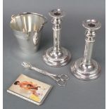 A pair of silver plated telescopic candlesticks together with an ice bucket and nips and a plated