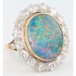 An 18ct yellow gold and platinum black opal and diamond ring, the oval centre stone approx. 5.9ct