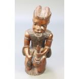 A carved African hardwood figure - The Snake Charmer 24"h