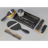 A silver mounted ebony dressing table set