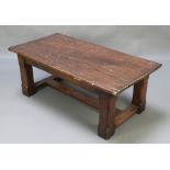 A rectangular rustic elm coffee table, the top of plank construction raised on square supports