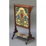 A Victorian carved rosewood adjustable fire screen fitted a folding shelf and with tapestry panel to
