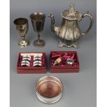 A silver plated coaster, 2 ditto cups, a teapot and 2 cased sets