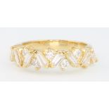An 18ct yellow gold diamond ring, set with brilliant and tapered baguette cut diamonds size M