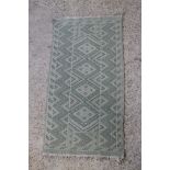 A Tunisian green ground flat weave rug 57" x 28"