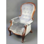 A Victorian mahogany show frame armchair upholstered in blue buttoned material, raised on cabriole