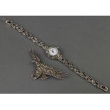 A silver and marcasite lady's wristwatch and silver and marcasite brooch in the form of an eagle