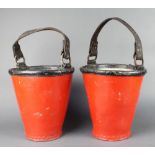 A pair of red and black painted leather fire buckets 11" x 10" diam.