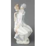 A Nao group of a seated lady and gentleman holding a bouquet of flowers behind his back 16"